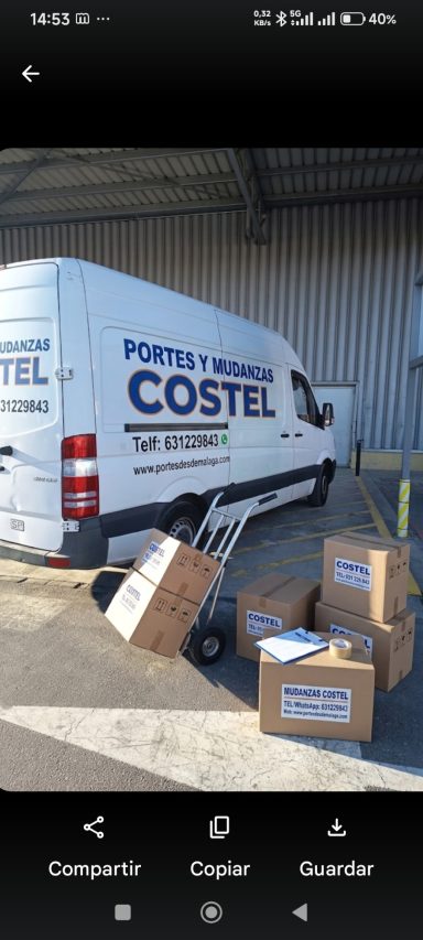 Furgoneta blanca de la empresa Costel con cajas apiladas al lado.